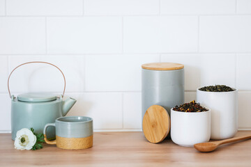 Kitchen table with teapot, cup and organizer storage box for tea