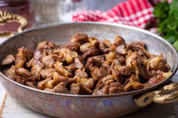 Muslims Traditional Sacrifice holiday food lamb, Turkish roasted meat in copper pot on table top. Turkish Kavurma. (Turkish name; Kurban kavurma)