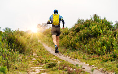 unknown man running outdoors or doing trail running, back view