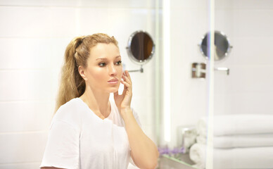 Fototapeta premium Applying the cream..Magic anti-aging cream.