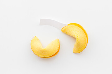 Broken Chinese fortune cookie with blank slip outside