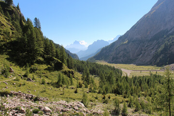 Fototapeta na wymiar Ombretta Valley with mountains on background in a sunny day, Italian Alps.