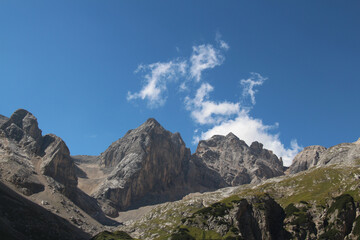 Mountain massif of Ombretta Valley in a sunny day, Italian Alps.