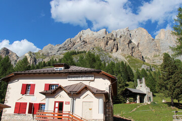 Fototapeta na wymiar Rifugio Efrem Reatto and mountain massif on background, Contrin Valey, Italian Alps.
