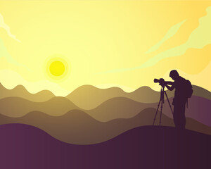 silhouette photographer on the hill taking photos of sunset and mountains