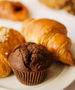 chocolate muffin, croissant, and assorted pastries