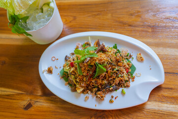 Grilled Catfish Larb recipe Thai call Larb Pla Duk, is a popular delicious Northeastern Thai food style. They use grilled catfish meat mixed with vegetable herbs and spices.