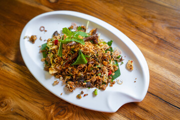 Grilled Catfish Larb recipe Thai call Larb Pla Duk, is a popular delicious Northeastern Thai food style. They use grilled catfish meat mixed with vegetable herbs and spices.