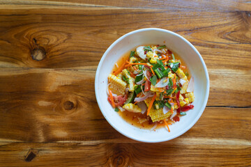 Papaya salad with corn or in Thai we call Som Tum Kao Pod with salted egg or Fruit Som Tum is popular delicious food in Northeastern Thai style.