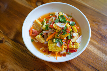 Papaya salad with corn or in Thai we call Som Tum Kao Pod with salted egg or Fruit Som Tum is popular delicious food in Northeastern Thai style.