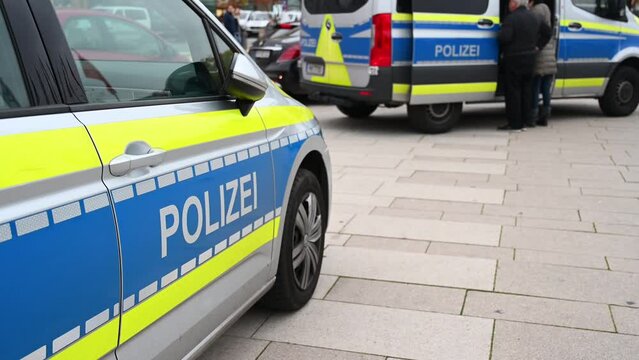 German police cars on the street. Side view of a police car with the lettering "Polizei".  Police patrol car parked on the street in Germany.