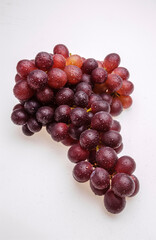 Bunch of grapes with water droplets isolated on white background.
