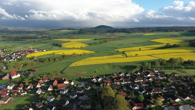 Aerial view of a German village surrounded by rapeseed fields, Marbach, Germany.