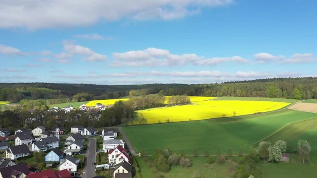 Aerial view of a German village surrounded by rapeseed fields, Marbach, Germany.