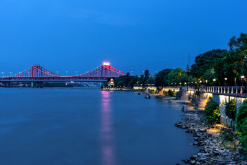 Cityscape of Dongjiang bridge in DongGuang, Guangdong, China. Night view of city bridge. Colorful lights reflected on the water. Translation:Dongjiang bridge.