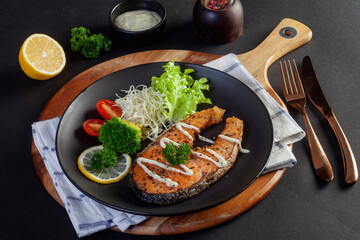 salmon steak on black background