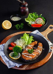 salmon steak on black background