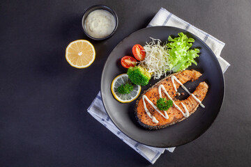 salmon steak on black background