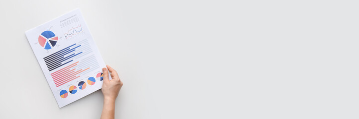 Human hand with business document on light background with space for text