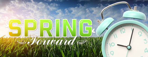 Alarm clock and green grass outdoors. Spring forward