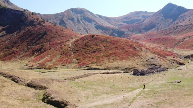 Woman Walks in Green Red Valley at Prokletije National Park, Montenegro - Drone Circling Pan