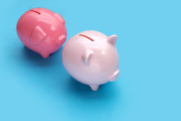 Pink piggy bank on blue background.