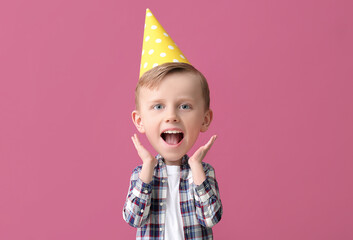 Surprised little boy with big head celebrating Birthday on color background