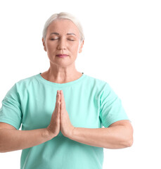 Meditating mature woman on white background
