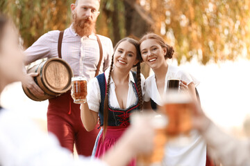 People with beer celebrating Octoberfest outdoors