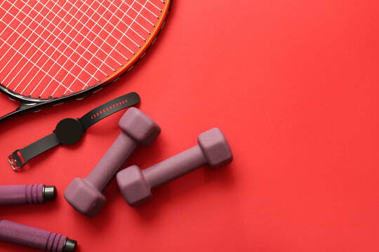 Stylish sport equipment on red background