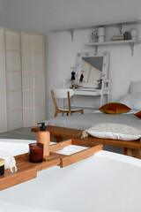 Stylish interior of bedroom with bathtub, closeup