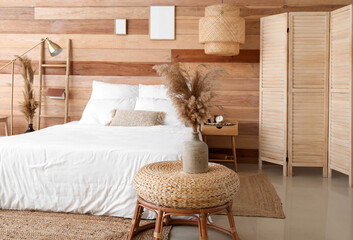 Interior of modern bedroom with wooden wall