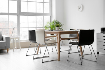 Interior of light conference hall with table and chairs
