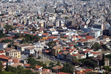 Obraz premium Historical columns in the middle of old town Athens view from Acropolis in Greece. Athens is one of the world's oldest cities.
