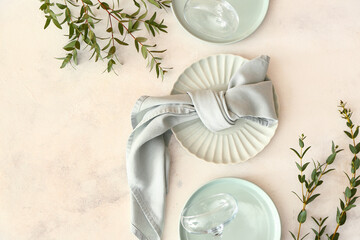 Stylish table setting and eucalyptus branches on light background