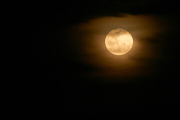 view of the full moon with few clouds
