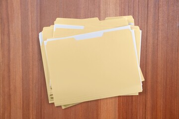 Paper file with documents on wooden table, top view. Space for text