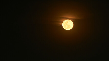 view of the full moon with few clouds