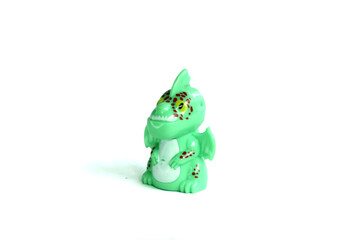 side view green dragon plastic toy isolated on white background.