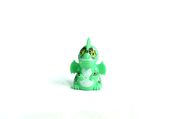 side view green dragon plastic toy isolated on white background.