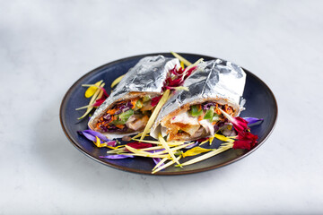 A view of a kati roll on a plate.