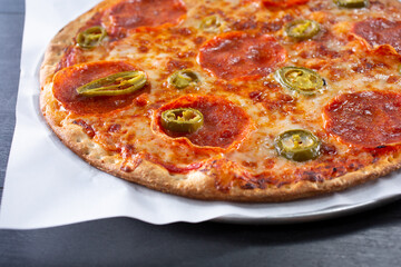 A view of a personal pepperoni and jalapeño pizza.