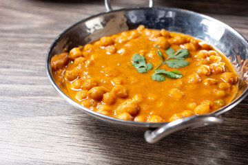 A view of channa masala, in a karahi bowl.