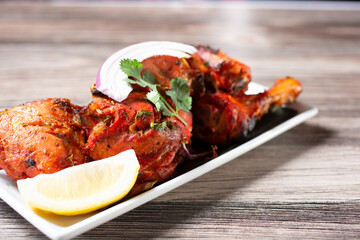 A view of a plate of tandoori chicken.