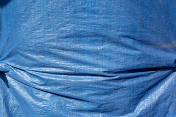 A view of a blue tarp, as a background. - obrazy, fototapety, plakaty