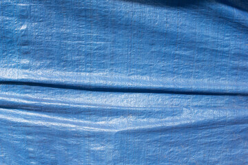 A view of a blue tarp, as a background. - obrazy, fototapety, plakaty
