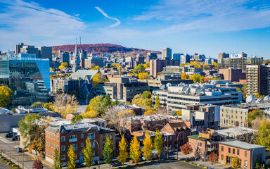 View on Montreal skyline, with Mount Royal in the background from the Jacques Cartier bridge, on a clear fall day © Pernelle Voyage