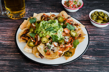 Mexican nachos chips with american cheese, beer and jalapeños in Mexico Latin America