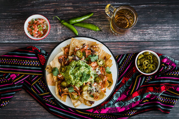 Mexican nachos chips with american cheese, beer and jalapeños in Mexico Latin America