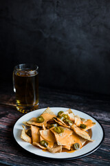 Mexican nachos chips with american cheese, beer and jalapeños in Mexico Latin America